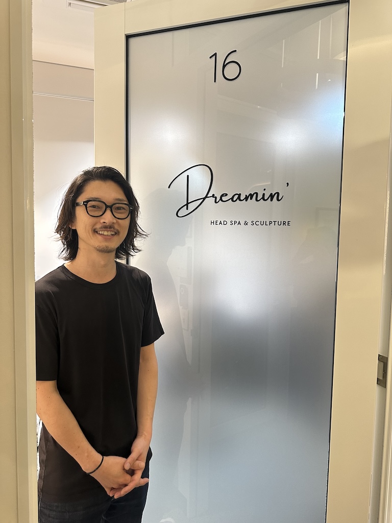Takashi Iwata, founder of Dreamin' Head Spa & Sculpture, at the door of the Southport studio