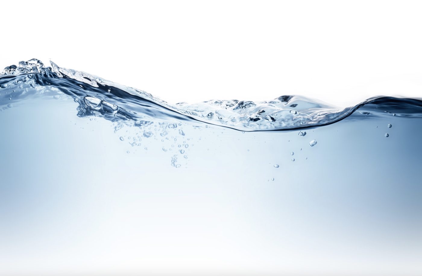 Clear water splashing against a white background, its surface catching the light
